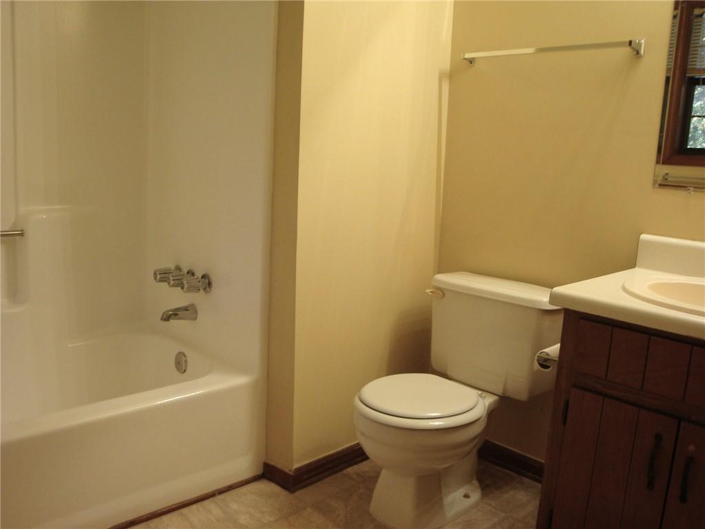 568 Russell Road Lawrenceville, GA 30043 - Photo 10 of 20 a bathroom with a toilet and a bathtub