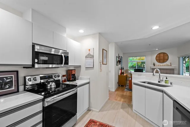 a kitchen with stainless steel appliances granite countertop a stove and a sink