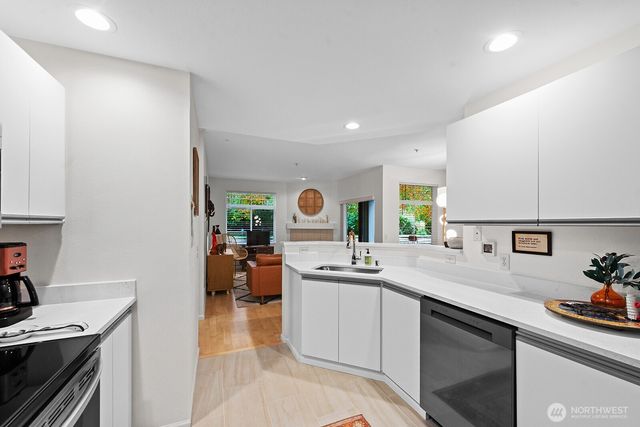 a kitchen with a sink stove and cabinets