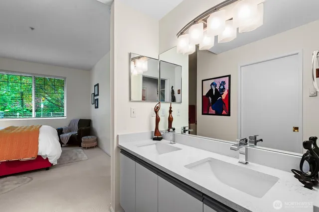 a bathroom with a double vanity sink and a mirror