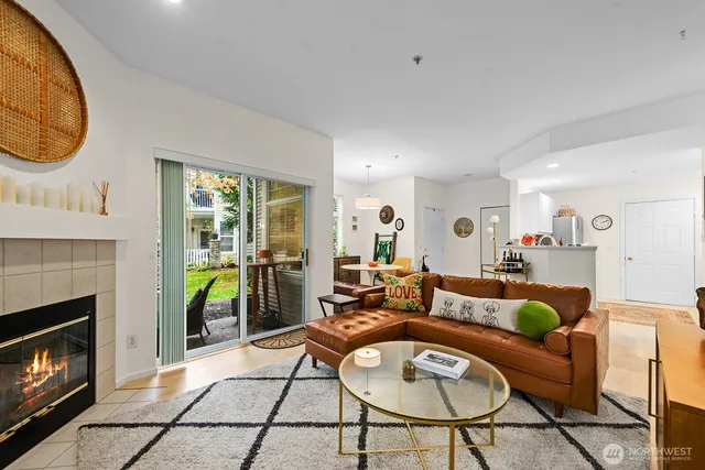 a living room with furniture a fireplace a clock and a fireplace