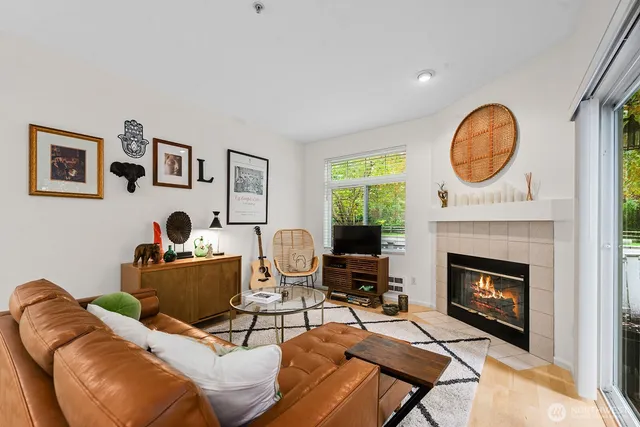 a living room with furniture a fireplace and window
