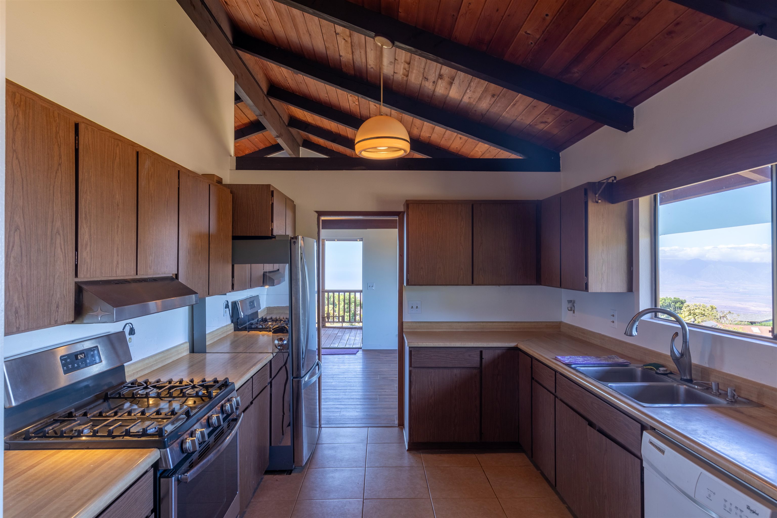 77 Kahoea Place Kula, HI 96790 - Photo 12 of 44 a kitchen with stainless steel appliances granite countertop a stove a sink and a microwave