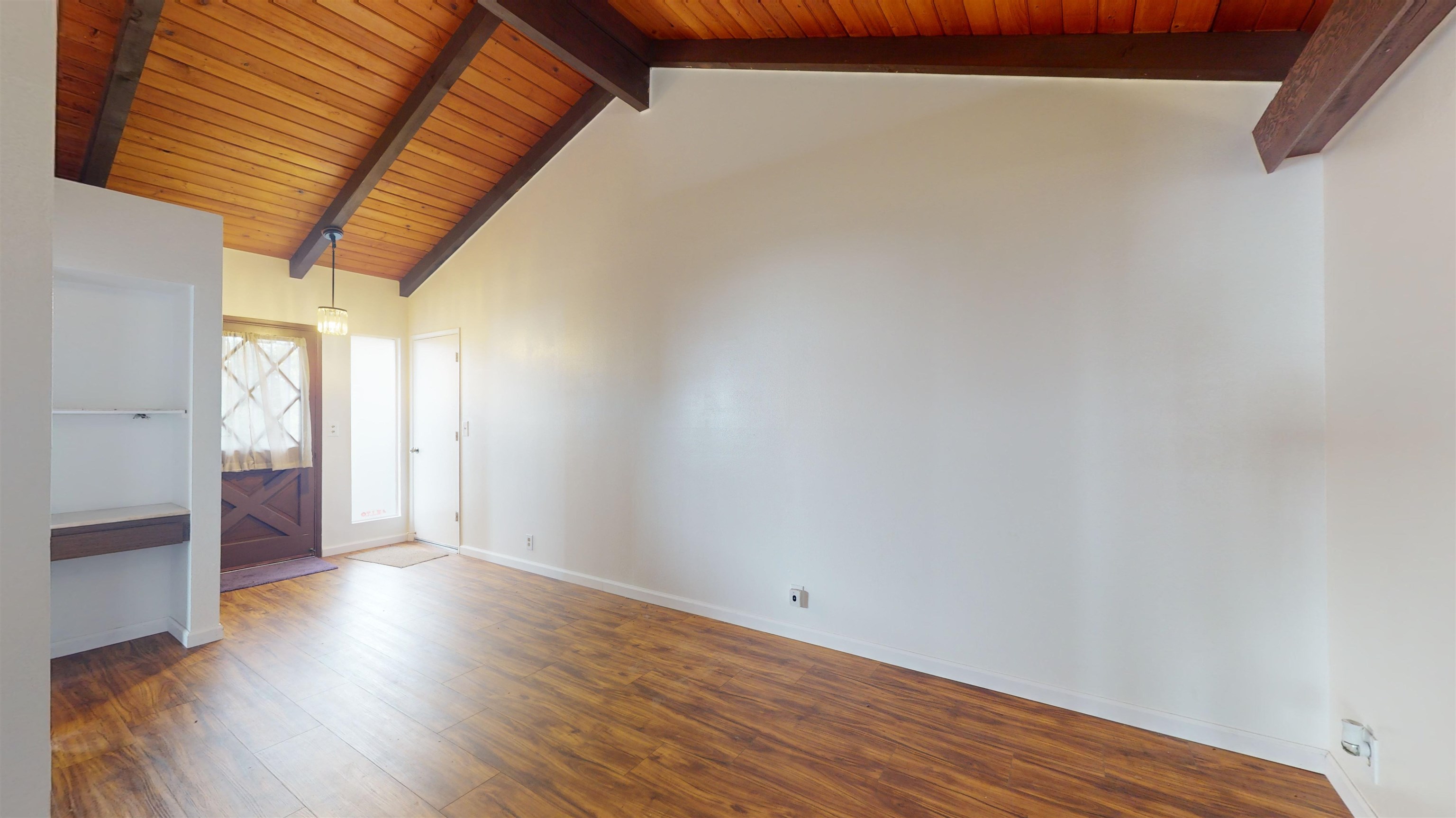 77 Kahoea Place Kula, HI 96790 - Photo 14 of 44 an empty room with wooden floor and windows