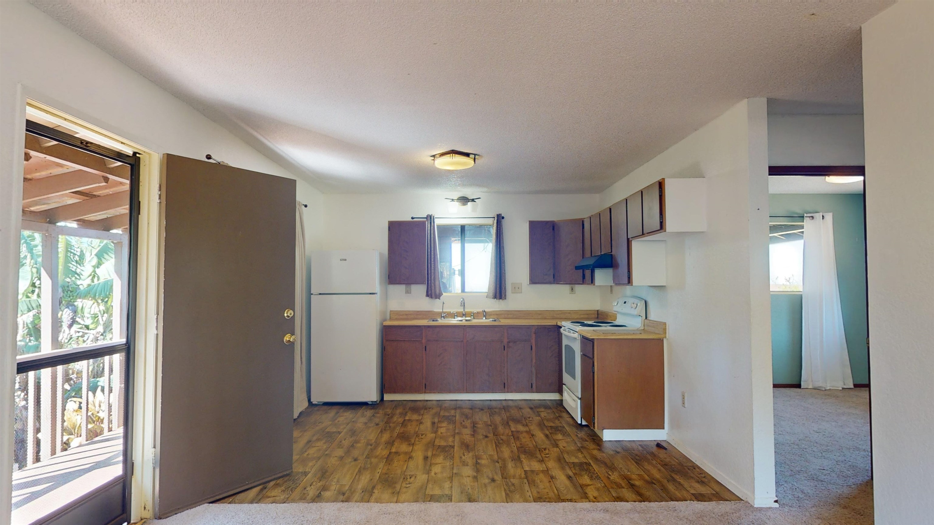 77 Kahoea Place Kula, HI 96790 - Photo 26 of 44 a kitchen with stainless steel appliances granite countertop a refrigerator and a sink