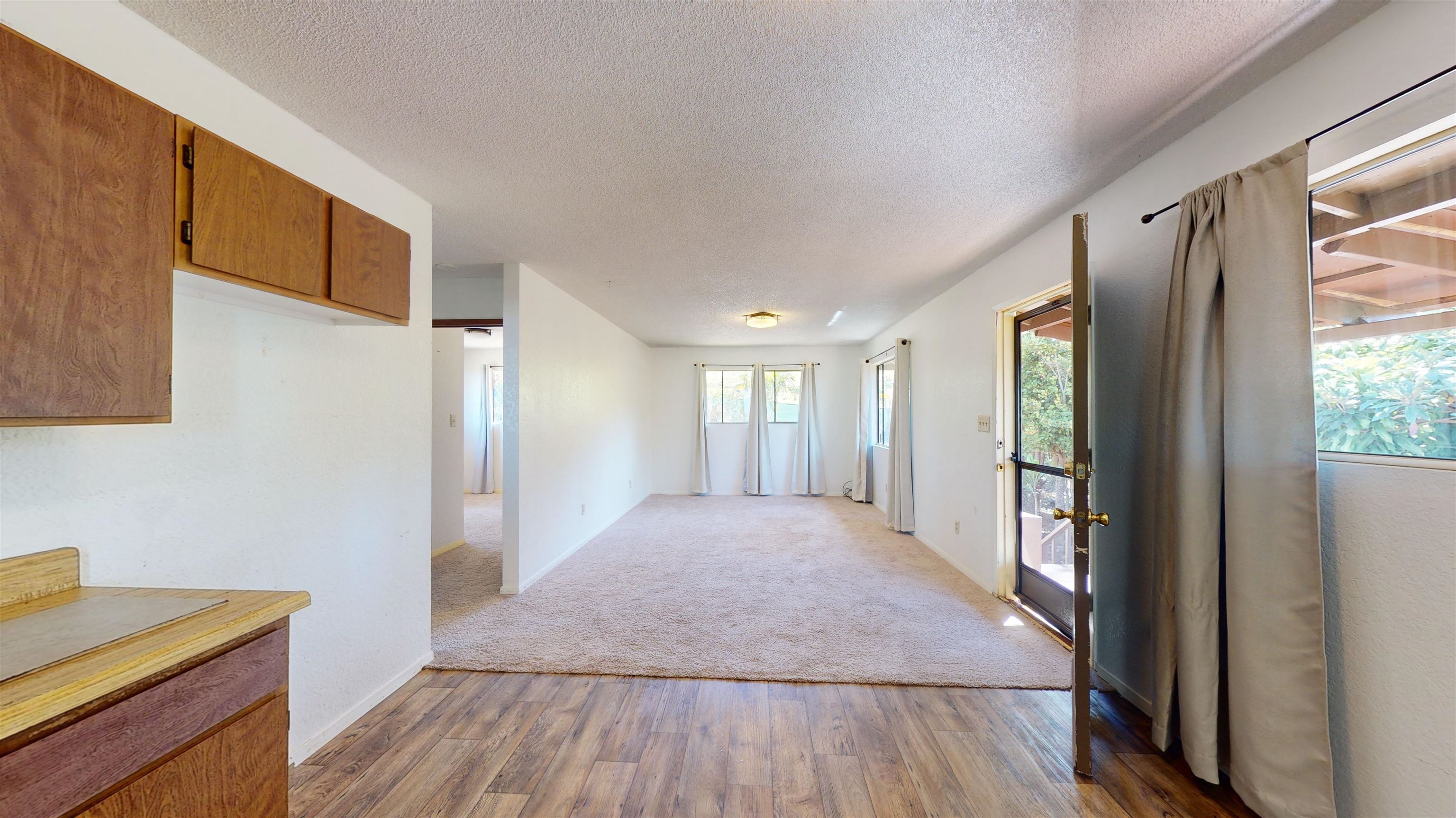 77 Kahoea Place Kula, HI 96790 - Photo 27 of 44 a view of a room with wooden floor and windows