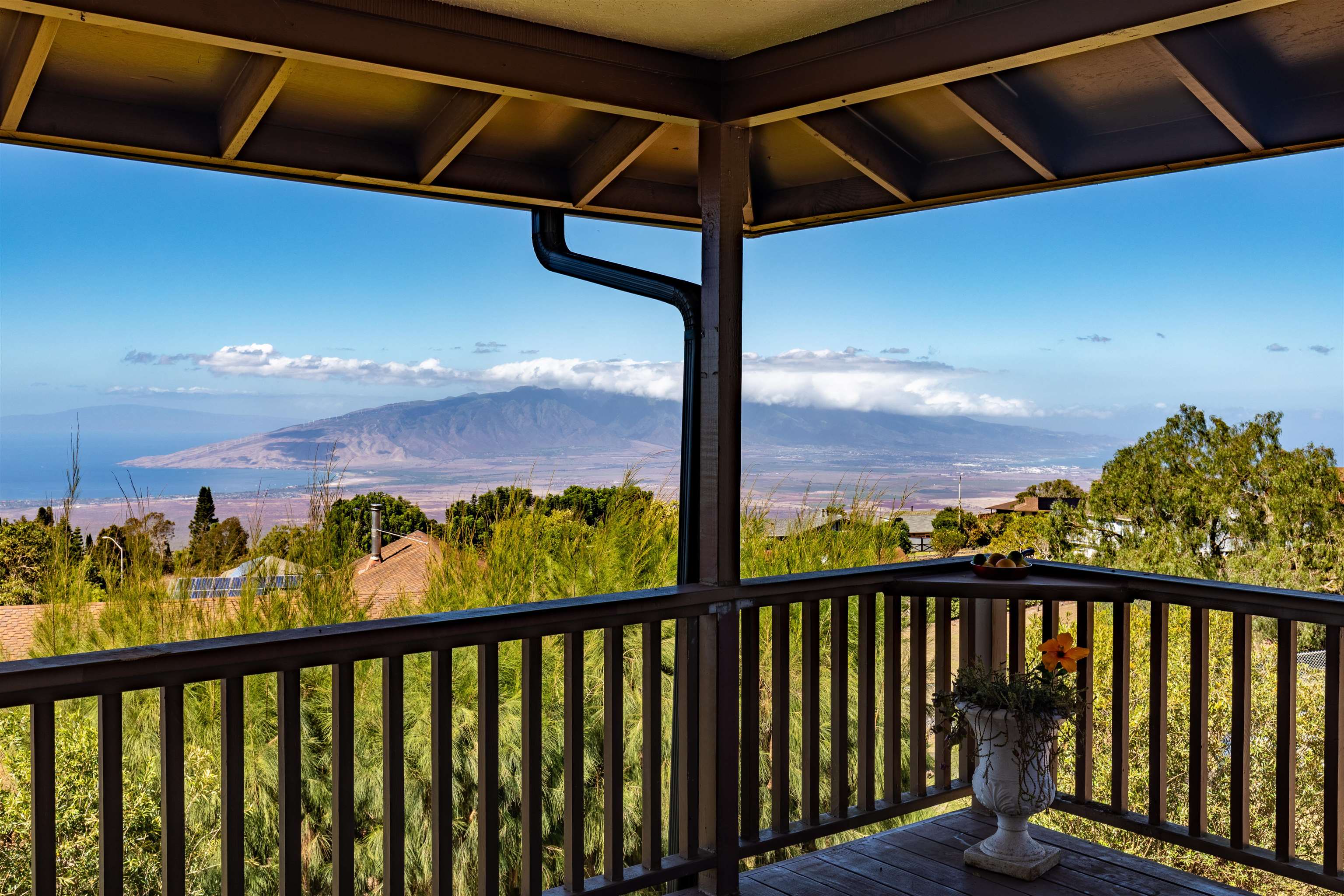 77 Kahoea Place Kula, HI 96790 - Photo 4 of 44 a view of a balcony with wooden floor & fence