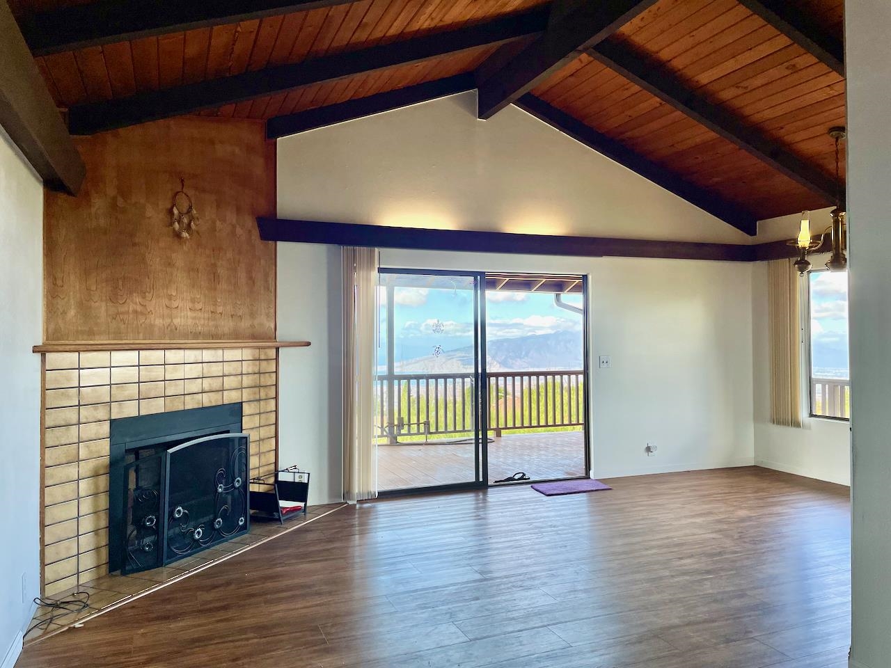 77 Kahoea Place Kula, HI 96790 - Photo 10 of 44 a view of an empty room with wooden floor and a window