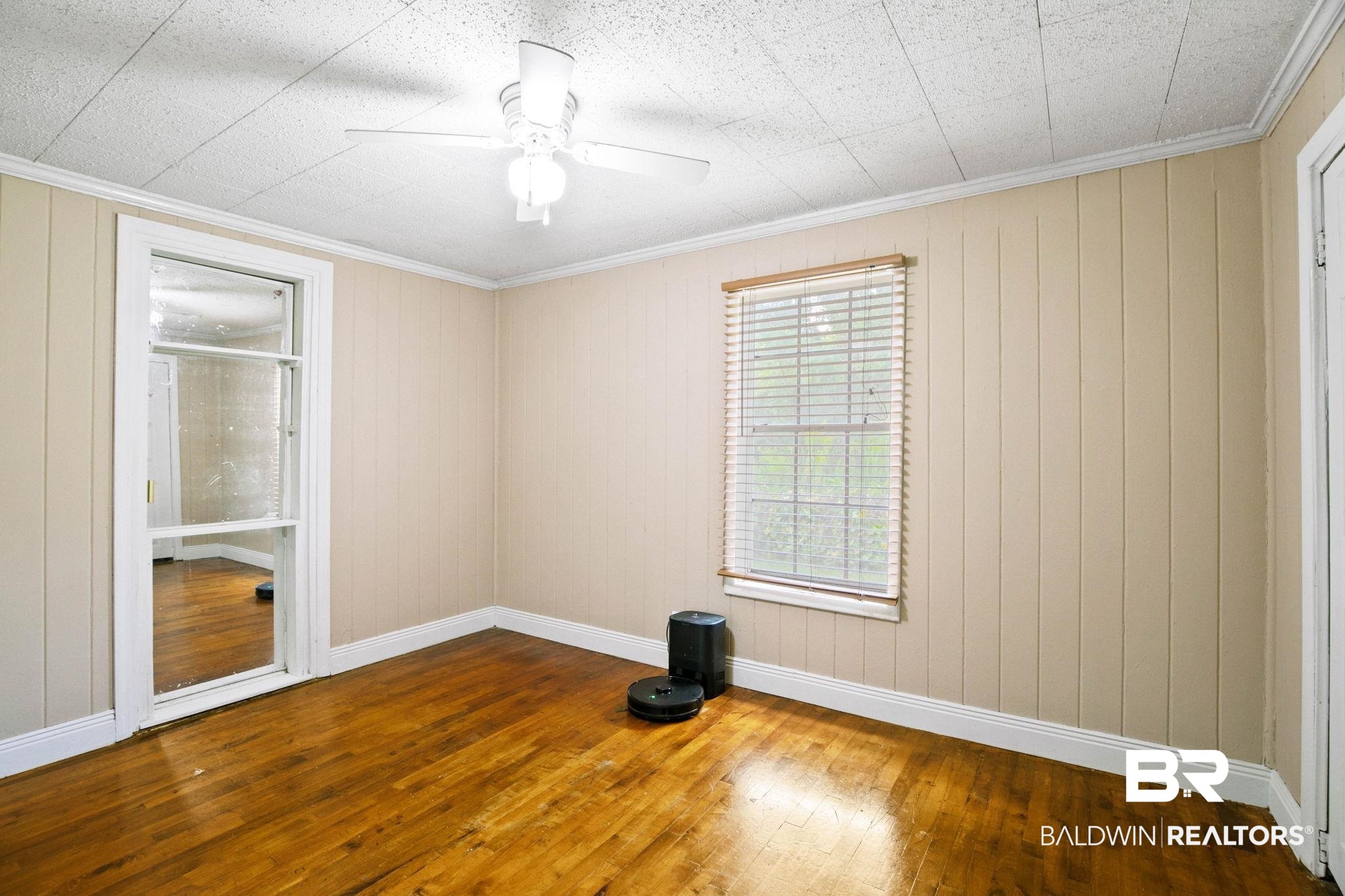 23240 County Road 47 Perdido, AL 36562 - Photo 21 of 29 Spare room featuring dark wood-style floors, ornamental molding, ceiling fan, and wood walls