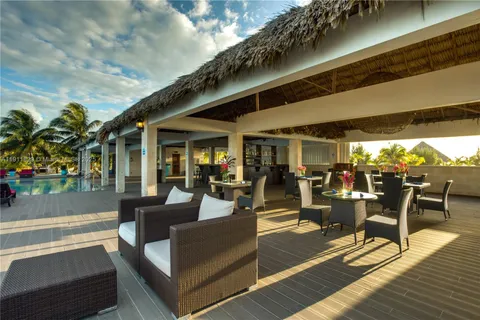 a view of a patio with dining table and chairs with wooden floor