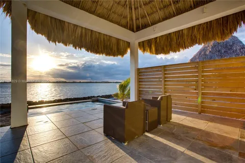 a dining room with furniture a chandelier and wooden floor