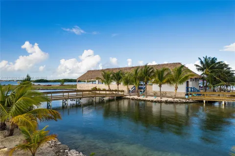 a view of swimming pool with outdoor seating and lake view