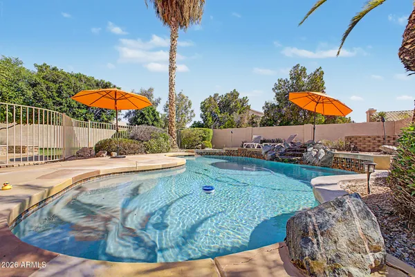 swimming pool view with a seating space