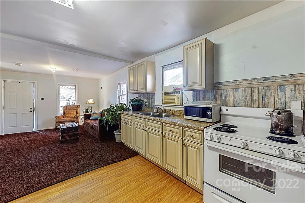 722 Morningside Road, Unit 97 Charlotte, NC 28214 - Photo 9 of 18 a kitchen with a stove cabinets and wooden floor