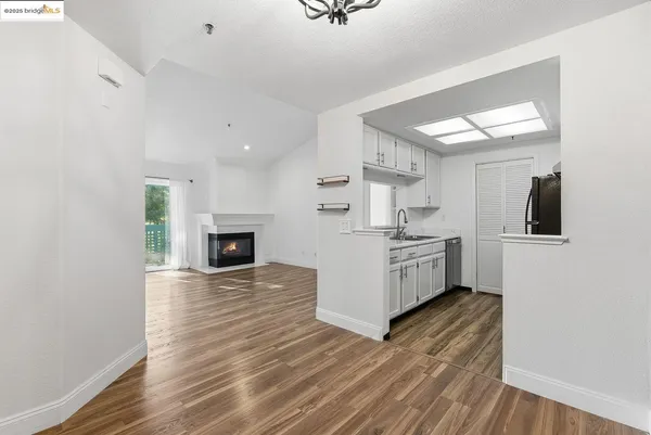 a view of kitchen with sink microwave and refrigerator