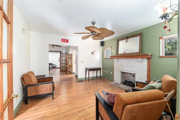 a view of an empty room with a window and a kitchen