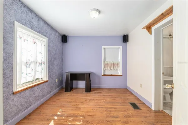 a view of a livingroom with hardwood floor and a ceiling fan
