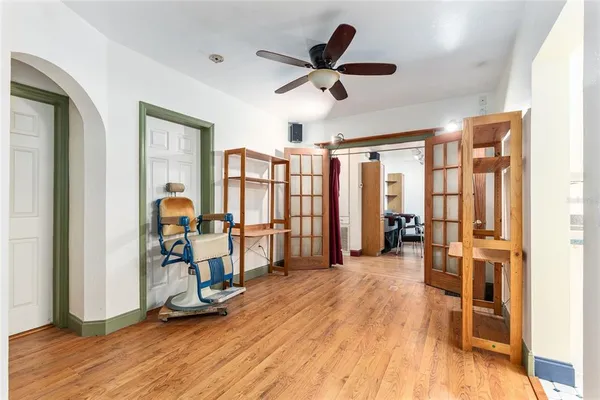 a living room with furniture a dining table and chairs with wooden floor