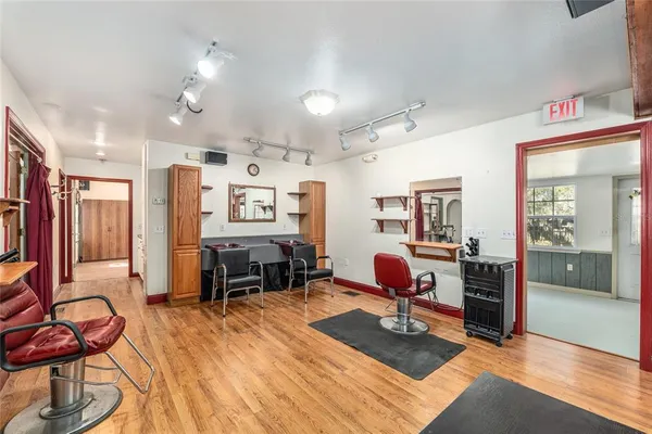 a living room filled with furniture and a wooden floor