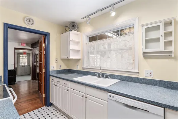 a view of a hallway with wooden floor and entryway
