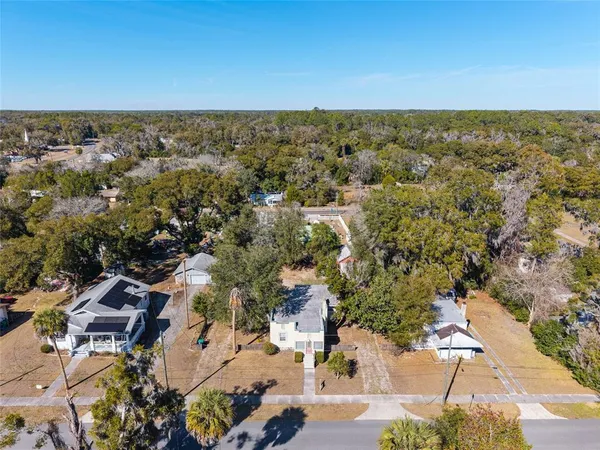 a view of a house with a small window and wooden fence