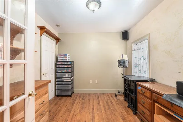 an aerial view of residential houses with outdoor space and trees