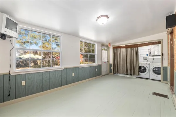an aerial view of a house with a yard and lake view