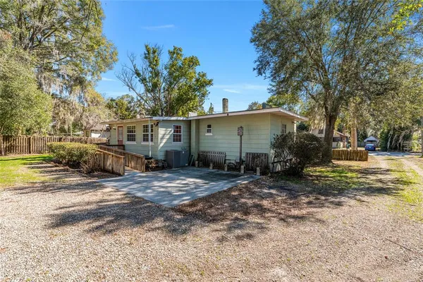 a view of a house with wooden fence
