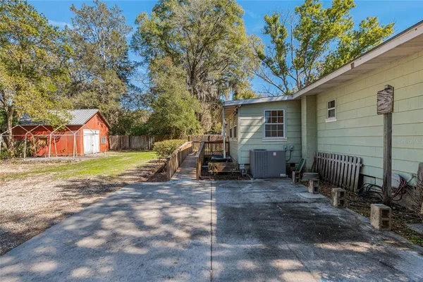 a backyard of a house with table and chairs