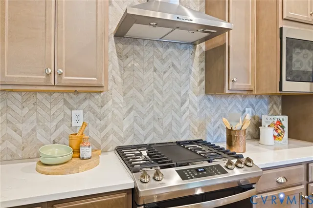 a kitchen with a sink a stove and chairs