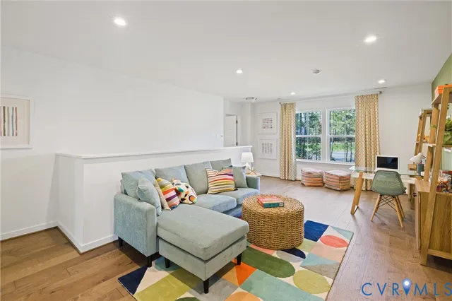 a bedroom with a bed and a flat tv screen on dresser
