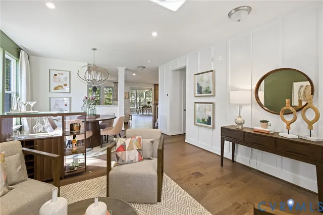 a living room with furniture and a wooden floor