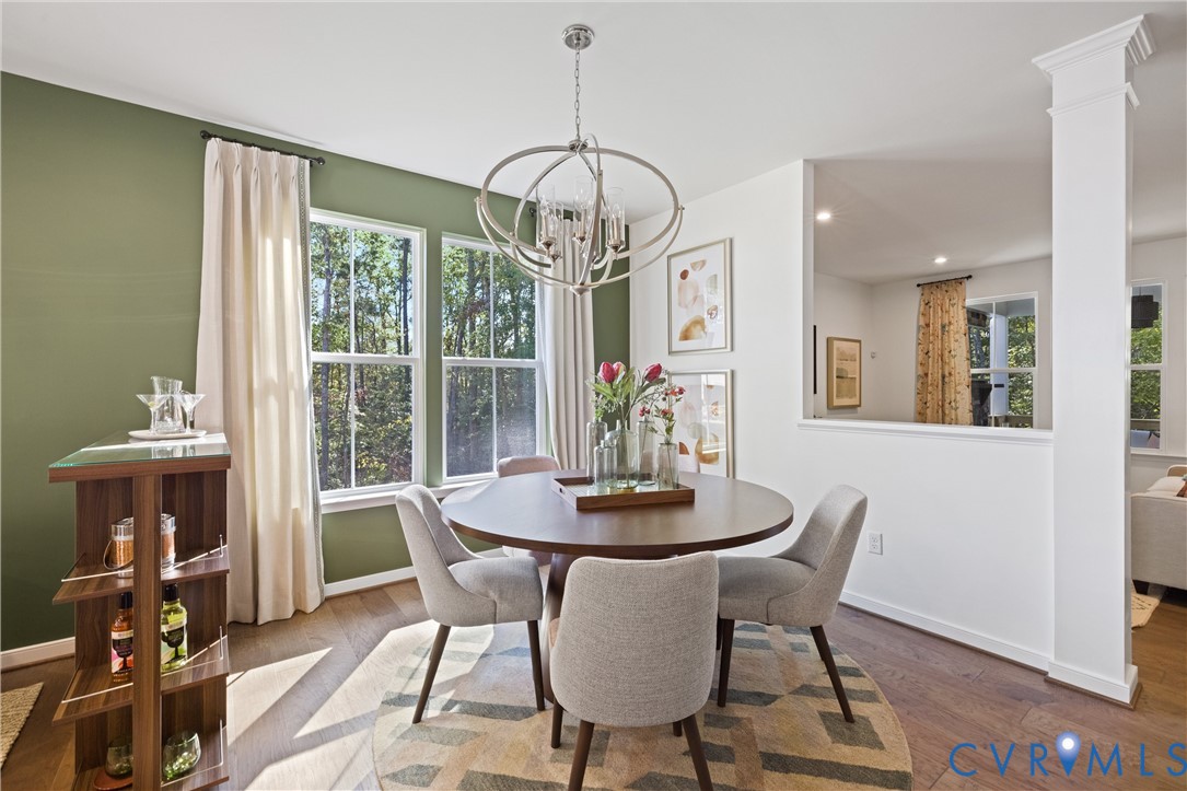 979 Charlemagne Road Midlothian, VA 23114 - Photo 5 of 50 a dining room with furniture a chandelier and wooden floor