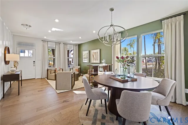 a view of a dining room with furniture wooden floor and chandelier