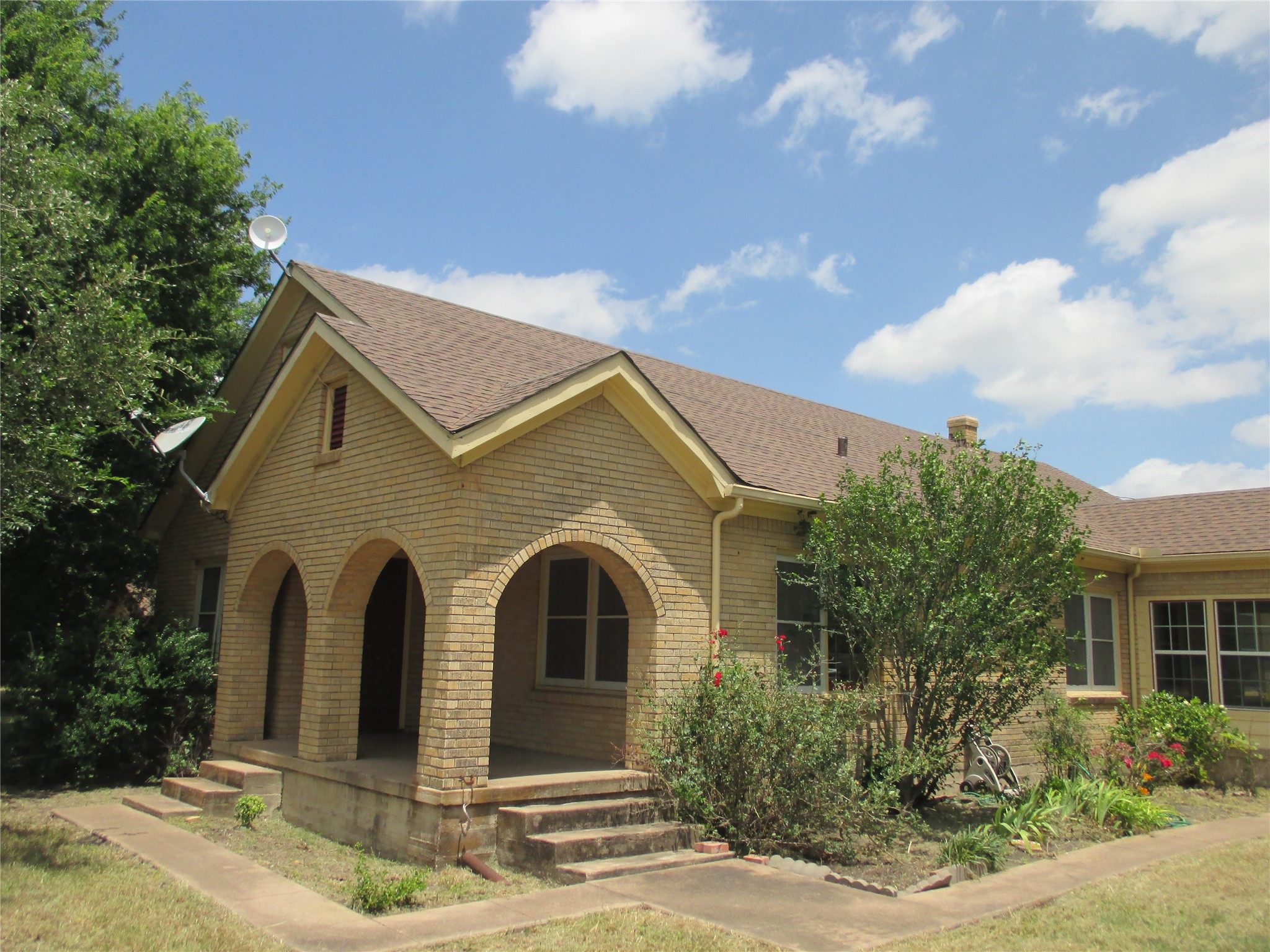 12610 Pecan School Road Bartlett, TX 76511 - Photo 1 of 21 A charming brick home featuring a welcoming arched front porch.