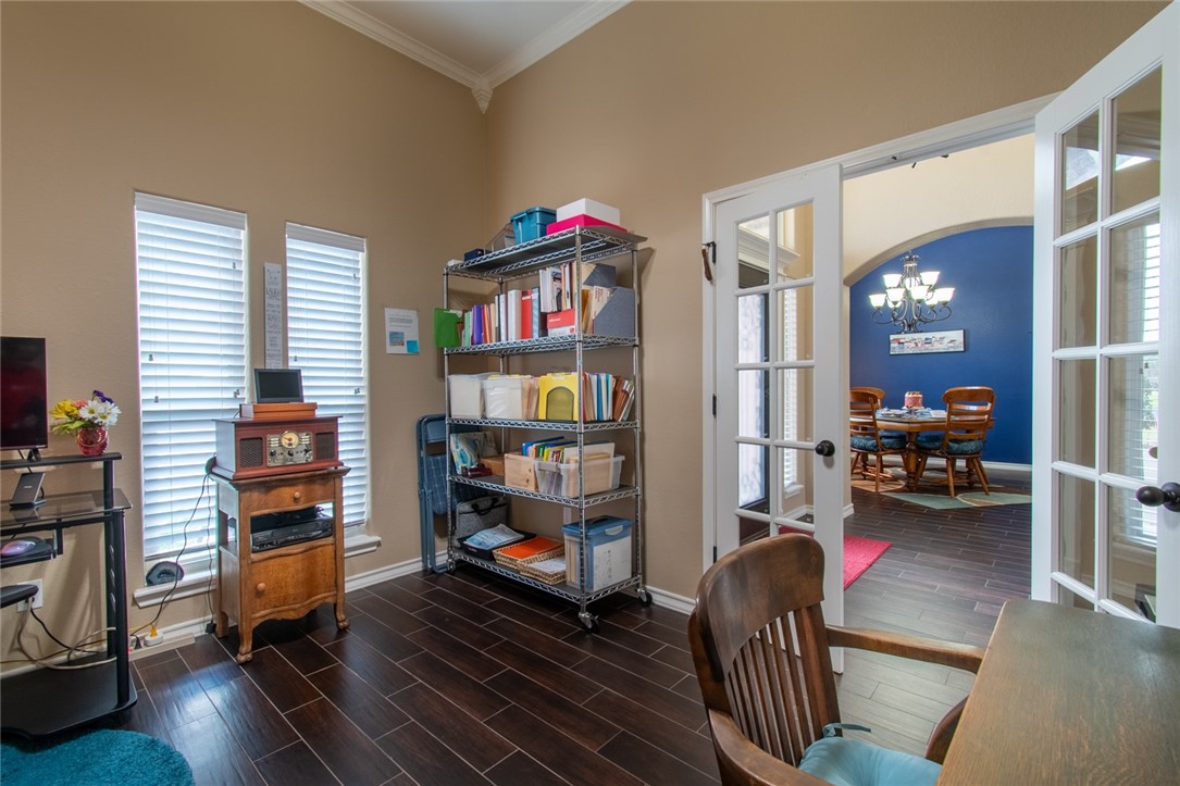 5309 Capernaum Court Corpus Christi, TX 78413 - Photo 13 of 40 a living room with furniture and a book shelf