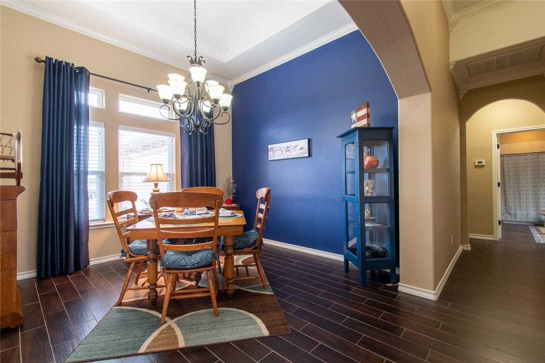 5309 Capernaum Court Corpus Christi, TX 78413 - Photo 14 of 40 a dining room with furniture a chandelier and wooden floor