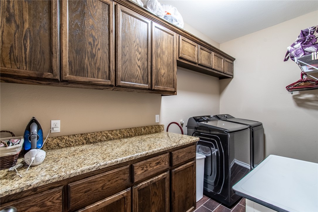 5309 Capernaum Court Corpus Christi, TX 78413 - Photo 16 of 40 a kitchen with granite countertop a sink a stove and cabinets