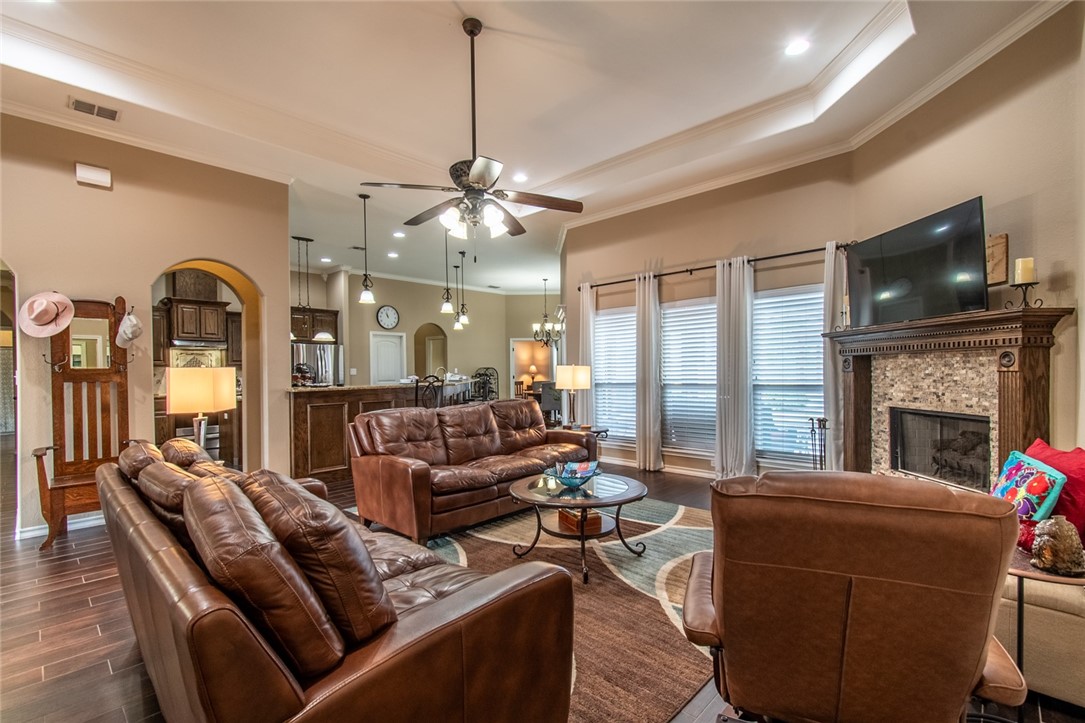 5309 Capernaum Court Corpus Christi, TX 78413 - Photo 17 of 40 a living room with furniture a fireplace and a flat screen tv