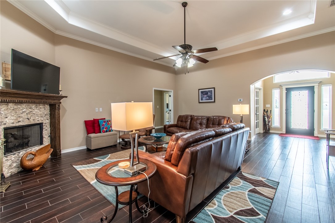 5309 Capernaum Court Corpus Christi, TX 78413 - Photo 19 of 40 a living room with furniture a flat screen tv and a fireplace