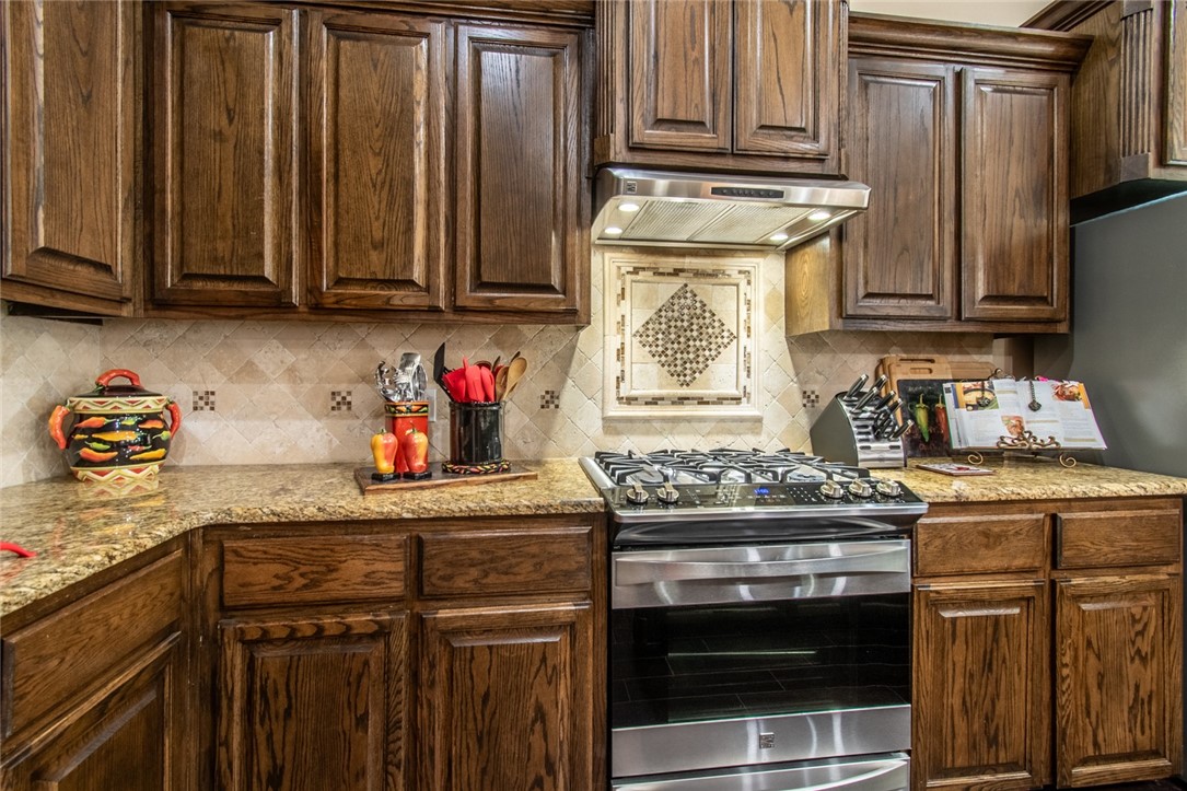 5309 Capernaum Court Corpus Christi, TX 78413 - Photo 26 of 40 a kitchen with stainless steel appliances granite countertop a stove and cabinets