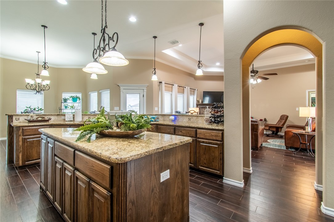 5309 Capernaum Court Corpus Christi, TX 78413 - Photo 28 of 40 a kitchen with a stove a sink a center island and wooden floor