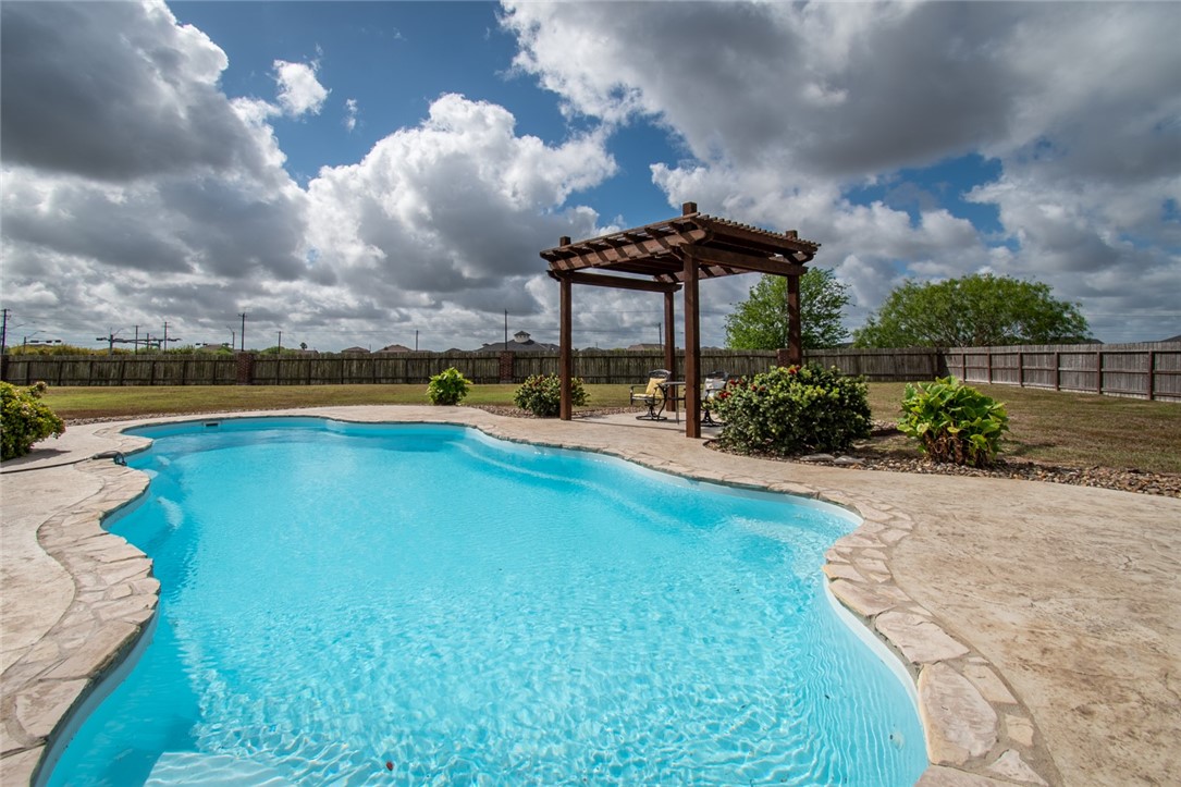 5309 Capernaum Court Corpus Christi, TX 78413 - Photo 37 of 40 a swimming pool with outdoor seating and garden