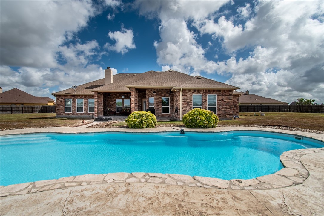 5309 Capernaum Court Corpus Christi, TX 78413 - Photo 40 of 40 a front view of a house with garden space and swimming pool