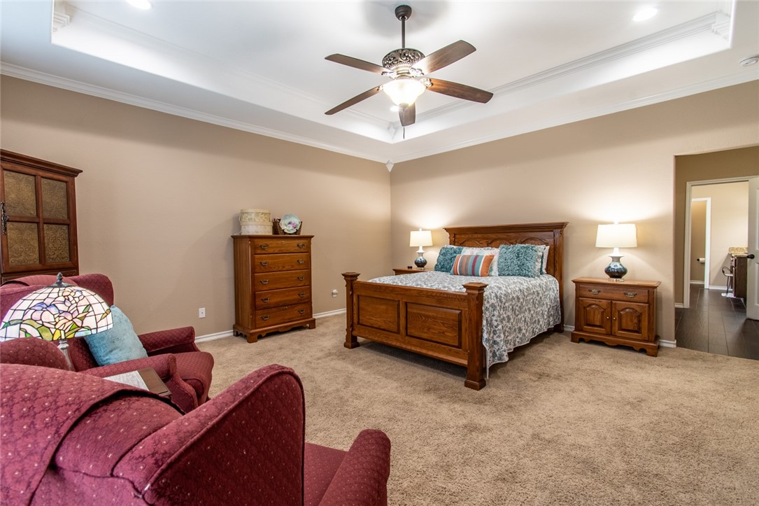 5309 Capernaum Court Corpus Christi, TX 78413 - Photo 4 of 40 a bedroom with bed and a chandelier