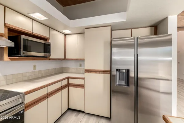 a kitchen with a refrigerator and microwave