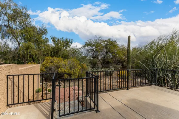 a balcony with trees in the background