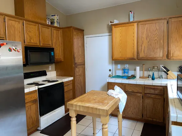 a kitchen with stainless steel appliances a stove a sink dishwasher and a refrigerator