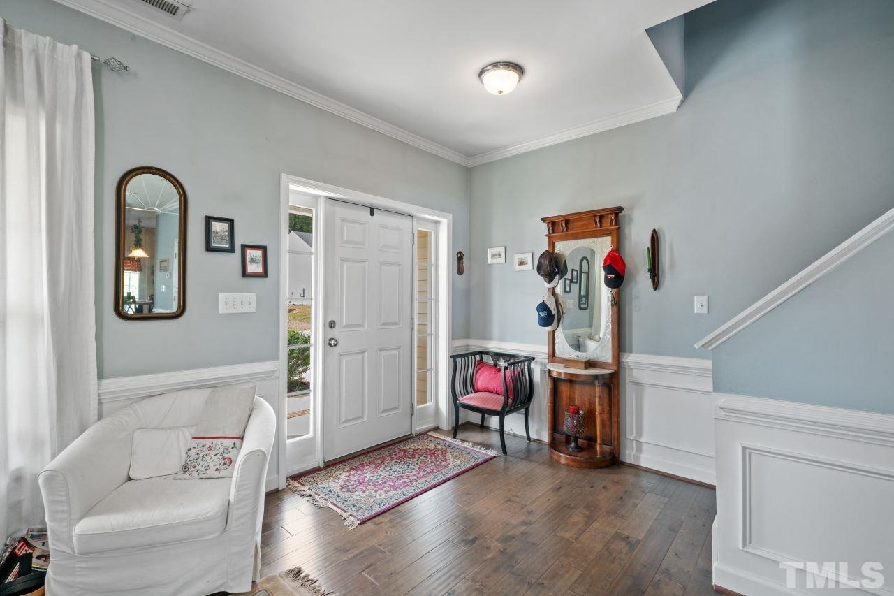 2307 King Malcolm Lane Zebulon, NC 27597 - Photo 2 of 30 a living room with furniture and a gym cycle