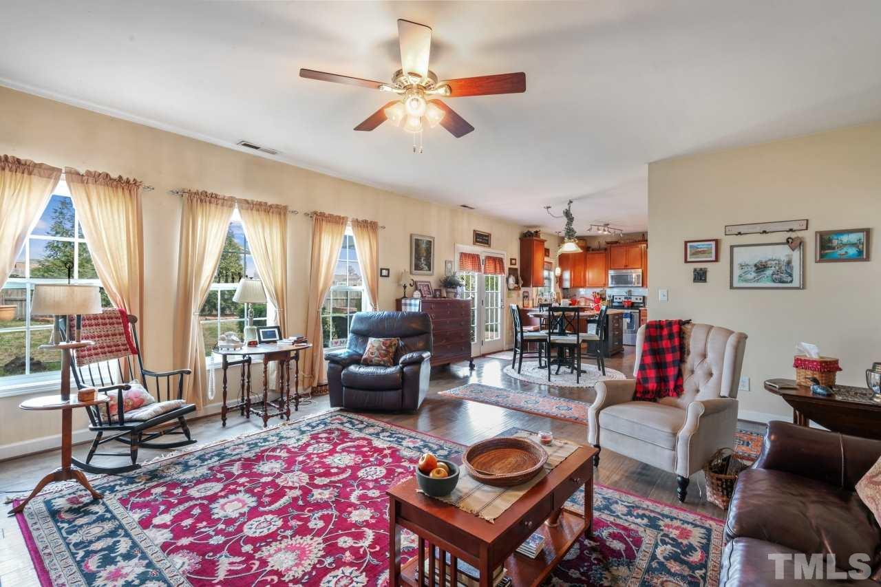 2307 King Malcolm Lane Zebulon, NC 27597 - Photo 13 of 30 a living room with furniture a rug and a large window